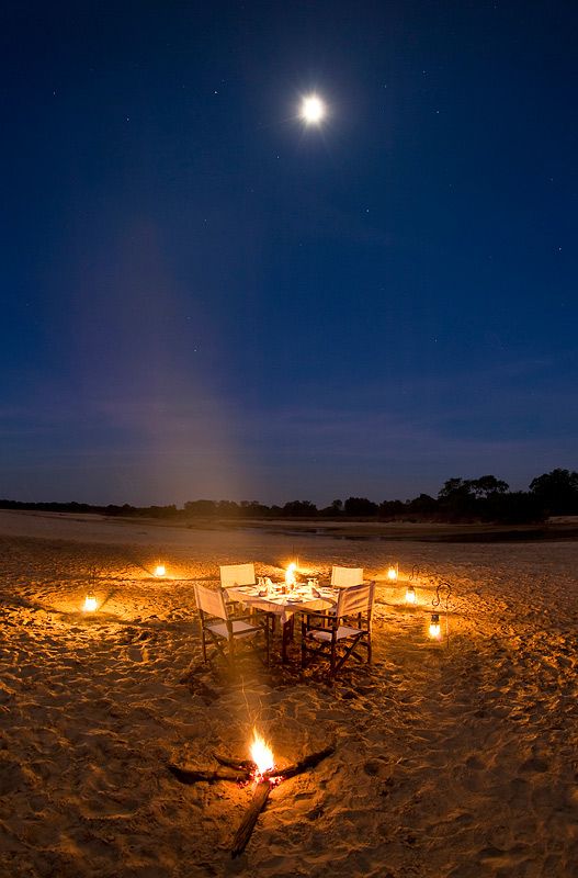 A fire-lit dinner beneath the moon